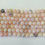 <p>Низка круглых гладких бусин из натурального камня - розового опала. В низке около 31 бусины. Оттенок может немного отличаться от представленного на фотографии. Цена за низку.</p>