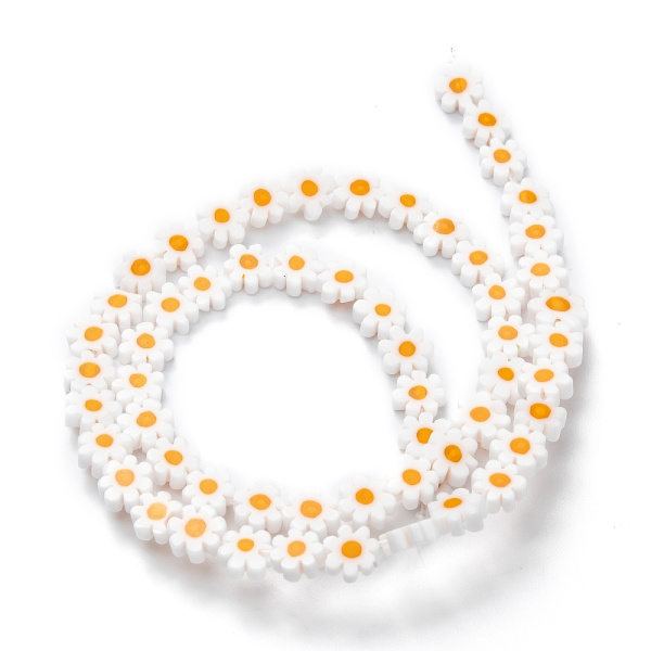 <p>Стеклянные бусины - цветочки ручной работы, выполнены в технике миллефиори (миллефьори). Бусины белого цвета с жёлтой серединкой, напоминают ромашки. У некоторых бусин не хватает лепестков. Оттенок может отличаться от фотографии и от партии к партии. Бусины могут существенно отличаться по форме и размеру. У бусин могут быть скошены лепестки. В низке около 26 бусин, низки формируются без проверки каждой бусины на дефекты. Цена за низку.
</p>