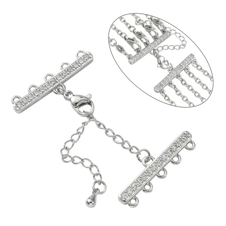 <p>Элитная ювелирная фурнитура премиум класса - Милано люкс (Milano Lux), качественный элемент для создания бижутерии. Набор для окончания многорядного украшения или широкого плетёного браслета/колье. В набор входят 2 соединителя-переходника с 5 на 1 нить размером 28*8 мм, инкрустированных кристально-прозрачными стразами - фианитами (Cubic Zirconia – кубик циркония, CZ, цирконы). К одному концевику прикреплена застежка карабин (лобстер), к другому - цепочка-удлинитель длиной около 5 см. и декоративной капелькой на конце. В застёгнутом виде длина концевиком вместе с замочком (без учёта удлинителя) составляет около 28 мм. Цвет под родий. Оттенок может отличаться от фотографии и в разных поставках. При желании концевики можно отсоединить и использовать как коннекторы или подвески. Цена за 1 набор.</p>