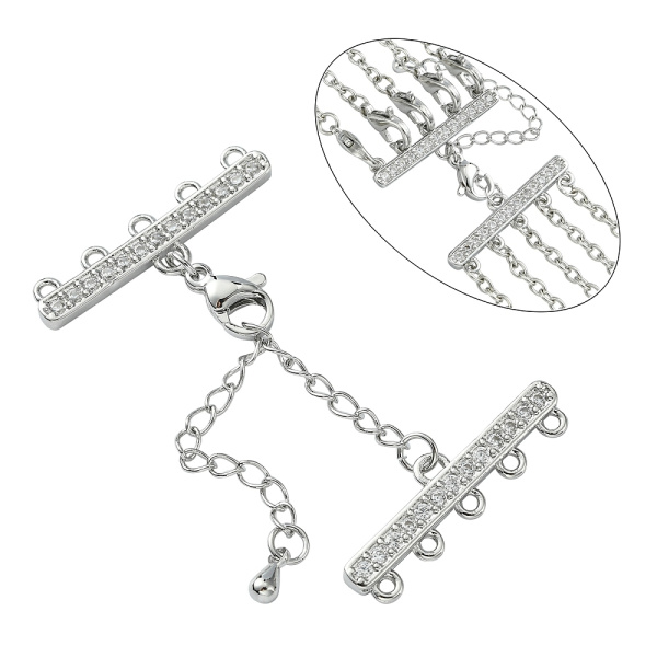 Застежка-карабин 10х6мм с удлиняющей цепочкой и соединителями-переходниками с пятью петельками 28х8мм, Milano, базовый материал - латунь, под родий <p>Элитная ювелирная фурнитура премиум класса - Милано люкс (Milano Lux), качественный элемент для создания бижутерии. Набор для окончания многорядного украшения или широкого плетёного браслета/колье. В набор входят 2 соединителя-переходника с 5 на 1 нить размером 28*8 мм, инкрустированных кристально-прозрачными стразами - фианитами (Cubic Zirconia – кубик циркония, CZ, цирконы). К одному концевику прикреплена застежка карабин (лобстер), к другому - цепочка-удлинитель длиной около 5 см. и декоративной капелькой на конце. В застёгнутом виде длина концевиком вместе с замочком (без учёта удлинителя) составляет около 28 мм. Цвет под родий. Оттенок может отличаться от фотографии и в разных поставках. При желании концевики можно отсоединить и использовать как коннекторы или подвески. Цена за 1 набор.</p>